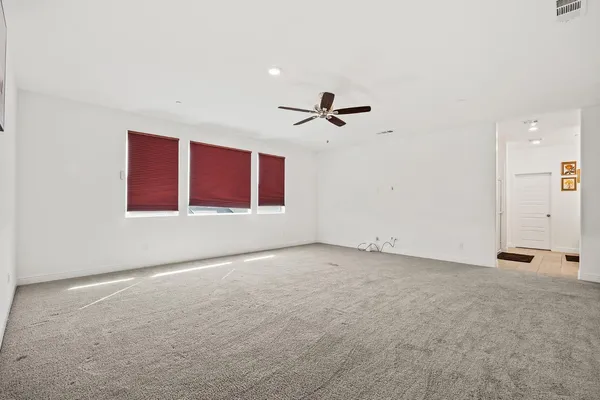 a view of an empty room with a ceiling fan