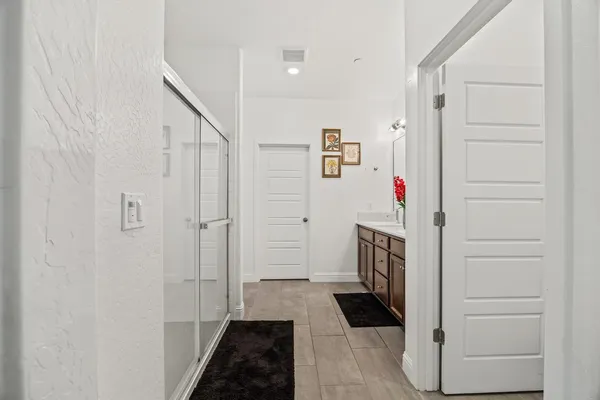 a hallway with cabinets and wooden floor