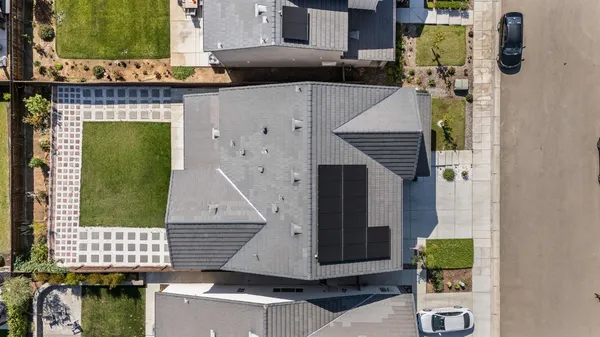 an aerial view of residential houses with outdoor space
