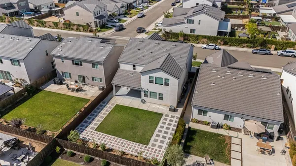 an aerial view of multiple houses with yard
