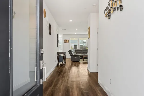 a view of a room with wooden floor and furniture