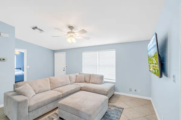 a kitchen with stainless steel appliances granite countertop a kitchen island hardwood floor sink stove dining table and chairs