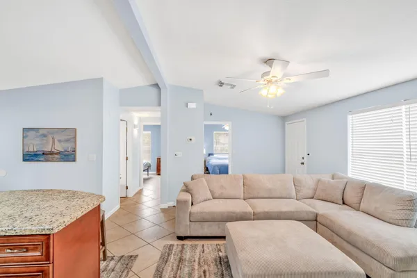 a kitchen with stainless steel appliances granite countertop a stove a refrigerator a oven a sink with island chairs and wooden cabinets