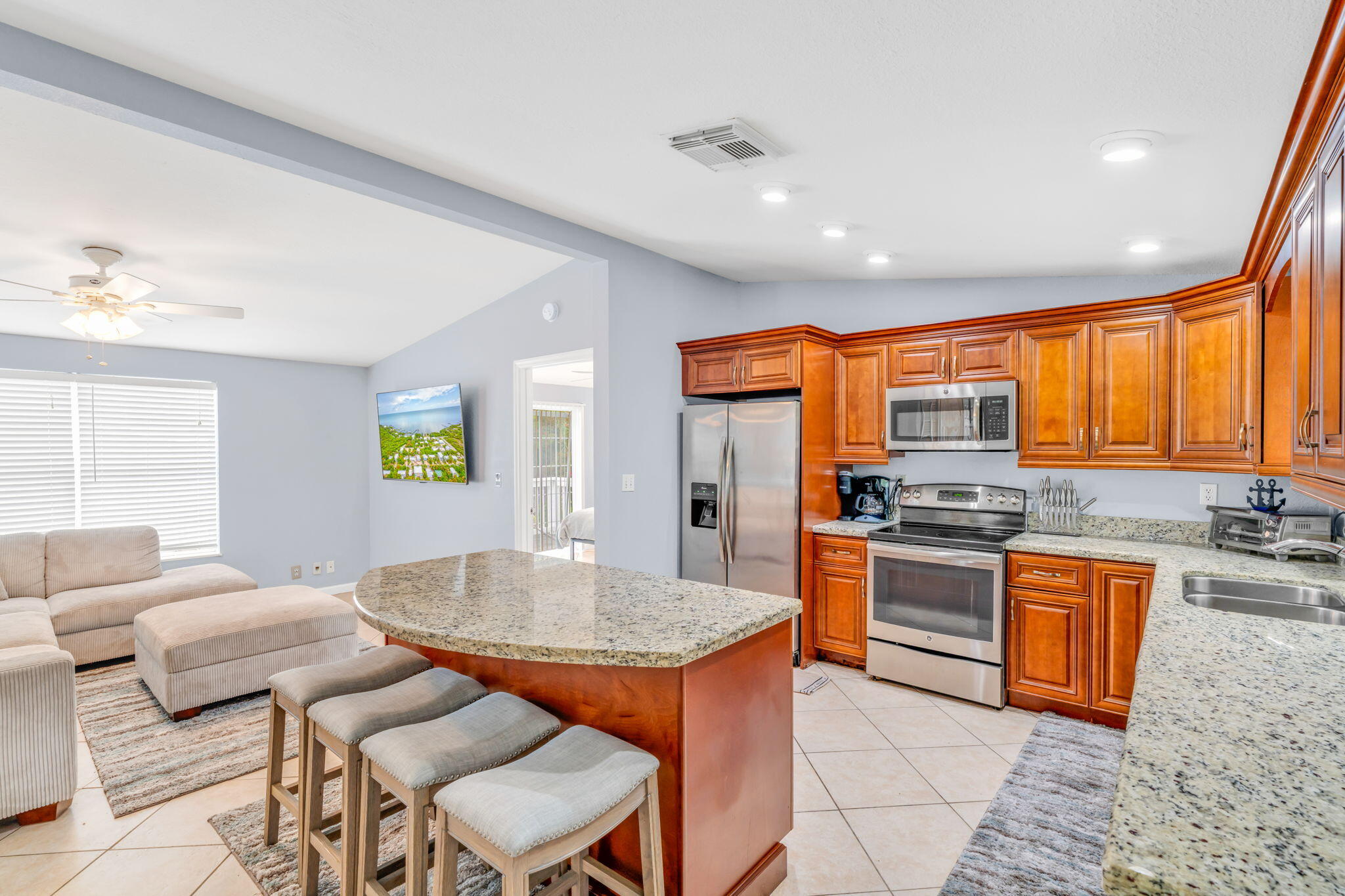 57485 Gibson Street Marathon, FL 33050 - Photo 20 of 33 a kitchen with stainless steel appliances granite countertop a kitchen island hardwood floor sink stove dining table and chairs