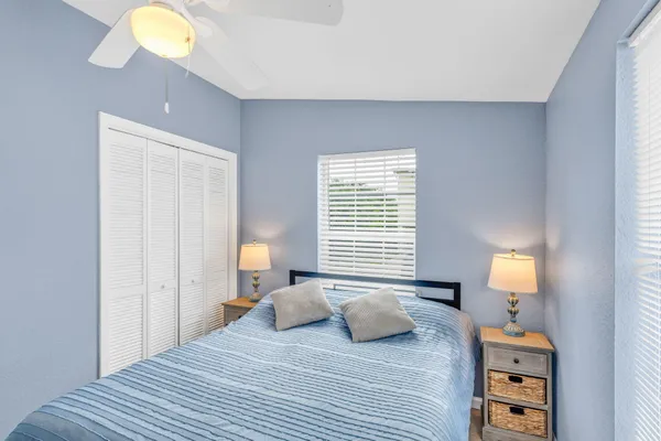 a spacious bedroom with a bed and a chandelier