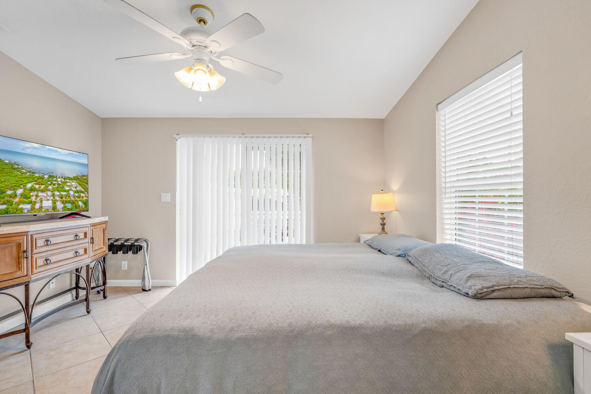 57485 Gibson Street Marathon, FL 33050 - Photo 28 of 33 a bedroom with a bed and a chandelier