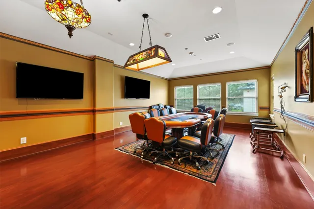 a spacious bedroom with a bed and a chandelier