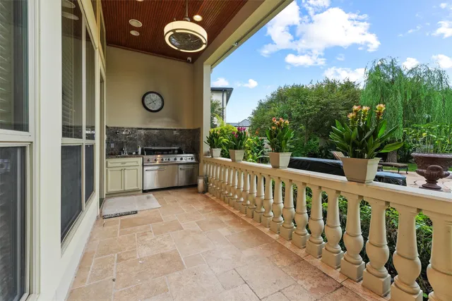 a view of a patio with table and chairs and potted plants