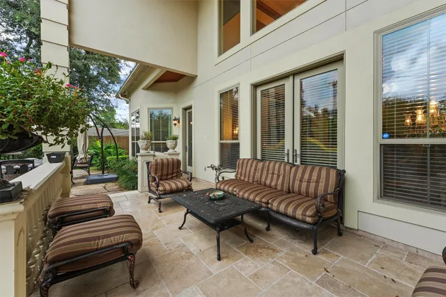 a front view of a house with swimming pool garden and patio