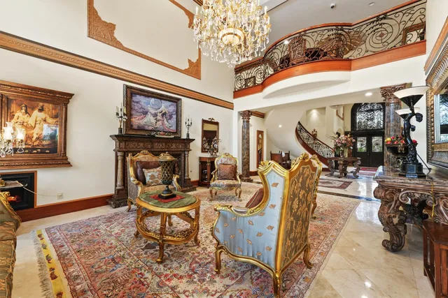 a view of a dining room with furniture a chandelier and wooden floor