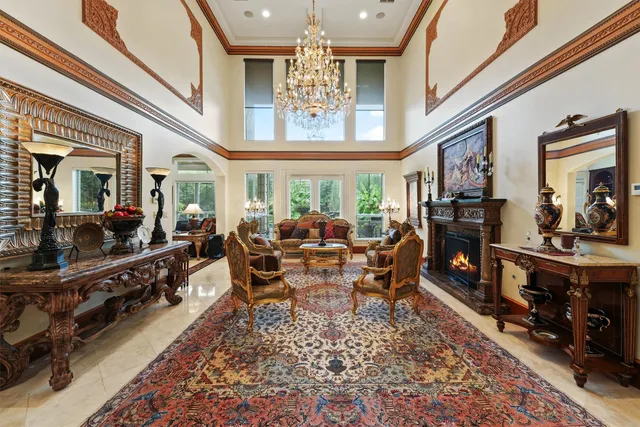 a living room with lots of furniture and a large window