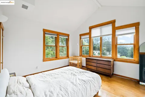 a bedroom with a bed and a large window