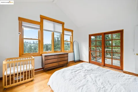 a bedroom with a bed and a large window