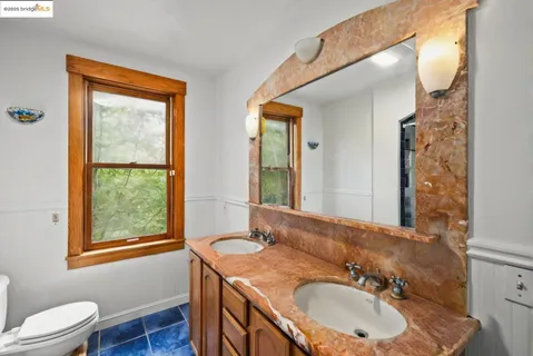 a bathroom with a sink mirror vanity and a window