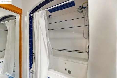 a bathroom with a glass shower door and a sink