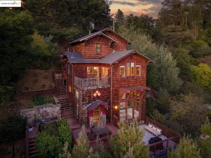 a view of a house with a yard and potted plants