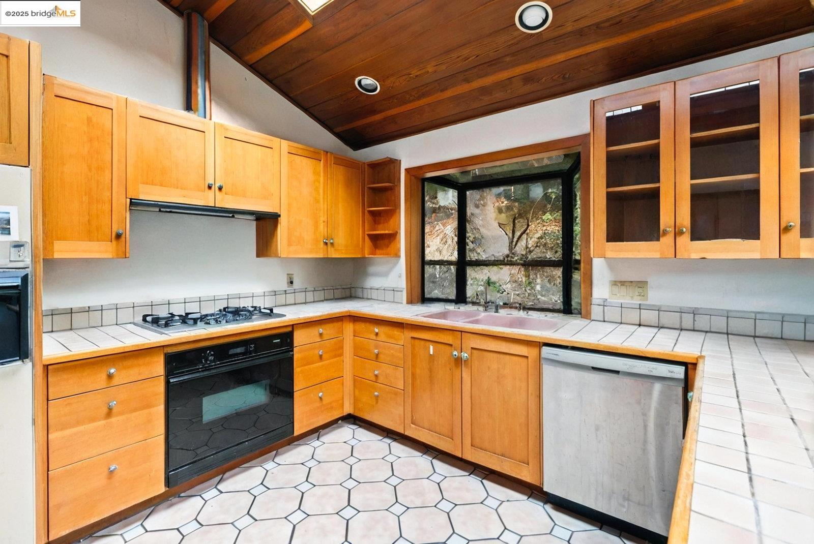 5663 Florence Terrace Oakland, CA 94611 - Photo 28 of 56 a kitchen that has a sink and a stove