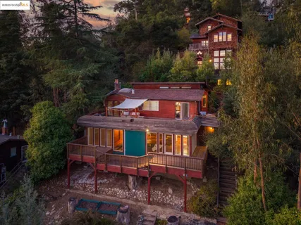 a front view of a house with yard and trees