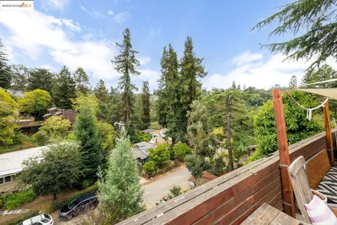 a view of balcony with wooden floor and fence