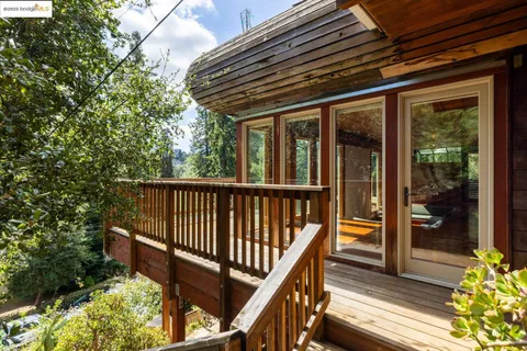 a view of balcony with wooden floor and fence