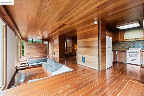 a view of balcony with floor to ceiling window and wooden floor