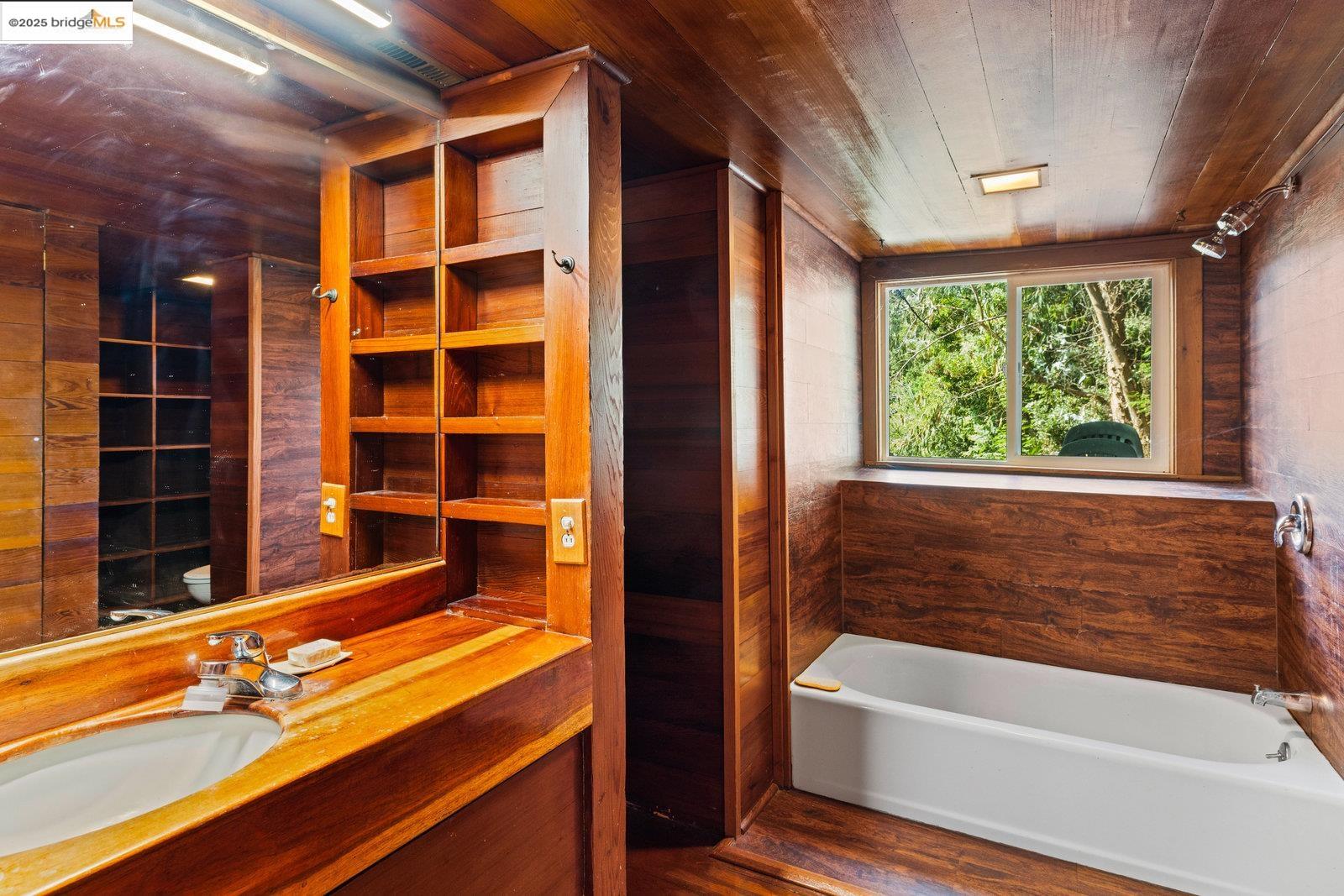 5663 Florence Terrace Oakland, CA 94611 - Photo 48 of 56 a bathroom with a bathtub and a window