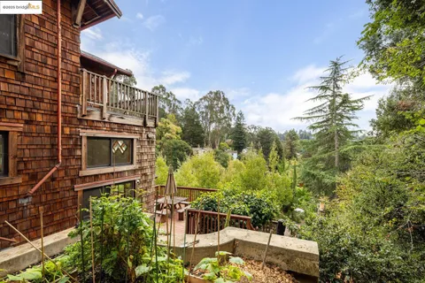 a backyard of a house with lots of green space and fountain