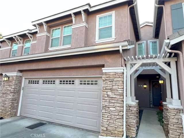 a front view of a house with garage
