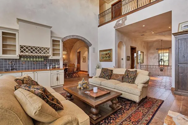 a close view of walk in closet with clothes and shoes