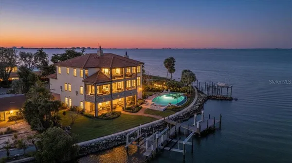 a view of a balcony with chairs and a potted plant