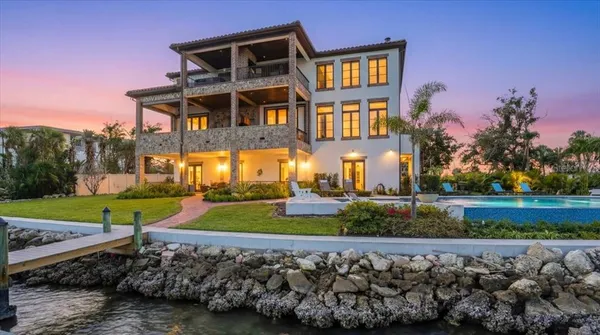 a view of a lake with couches chairs