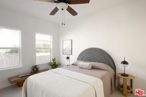 a bedroom with a bed and window