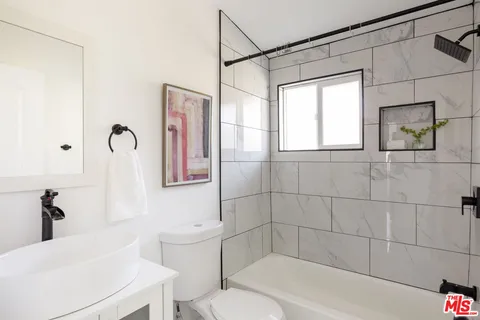 a bathroom with a toilet sink and bathtub