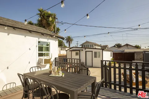 a view of a roof deck with table and chairs