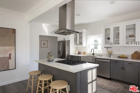 a kitchen with stainless steel appliances a sink and a stove
