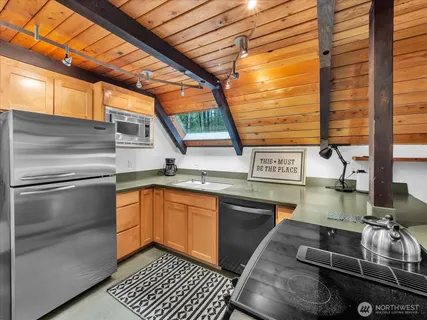 a kitchen with stainless steel appliances granite countertop a sink and cabinets