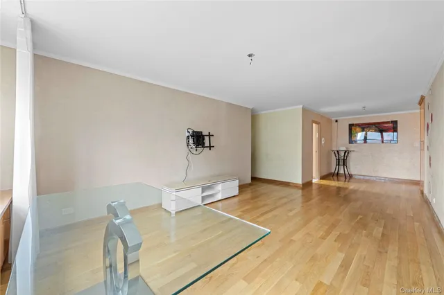 a view of empty room with wooden floor