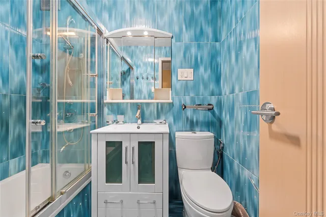 a bathroom with a toilet a sink and shower