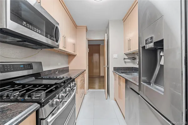 a kitchen with stainless steel appliances granite countertop a stove and a refrigerator