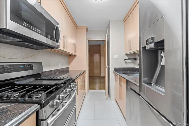 a kitchen with stainless steel appliances granite countertop a stove and a refrigerator