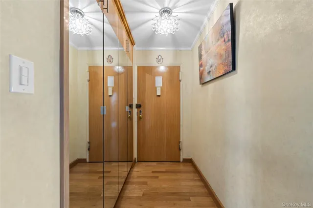 a view of a hallway with wooden floor and entryway