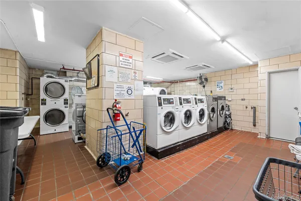 a utility room with multiple dryer and washer