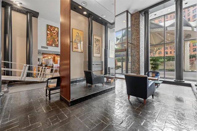 a living room with furniture and large windows