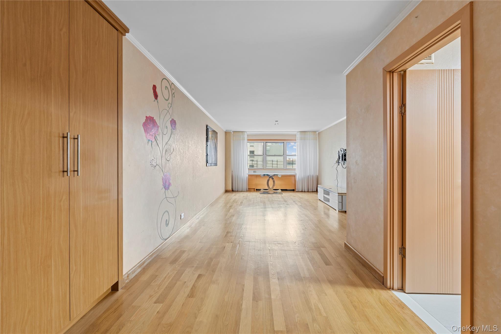 102-10 66th Road, Unit 3B Queens, NY 11375 - Photo 2 of 26 a view of a hallway with wooden floor and closet