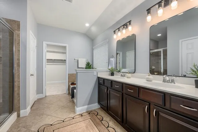 a spacious bathroom with a double vanity sink and a mirror