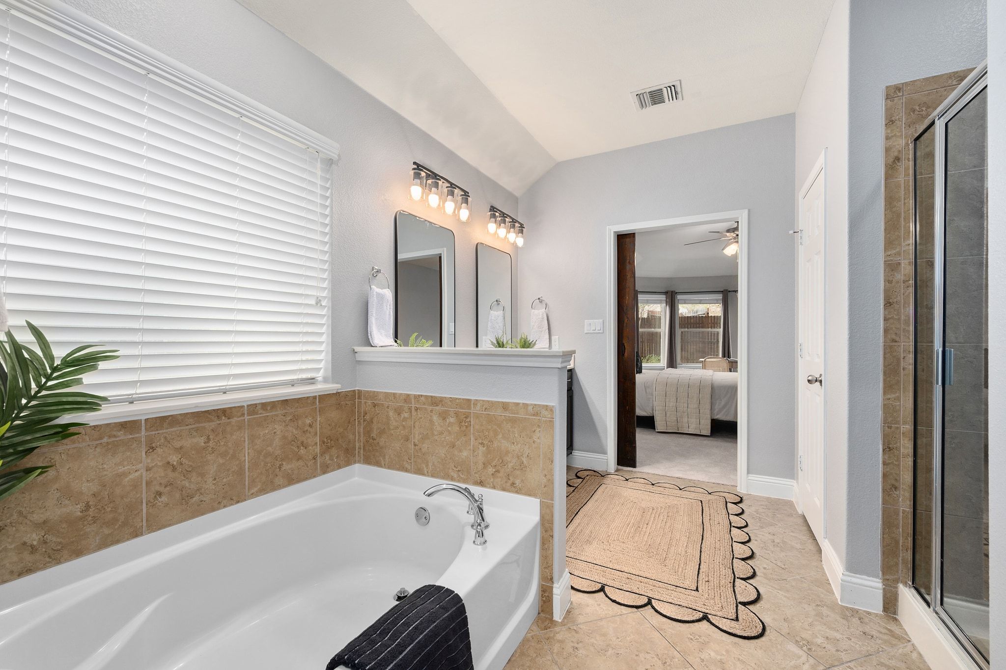 2041 Elaina Loop Leander, TX 78641 - Photo 15 of 25 a bathroom with a tub and a potted plant