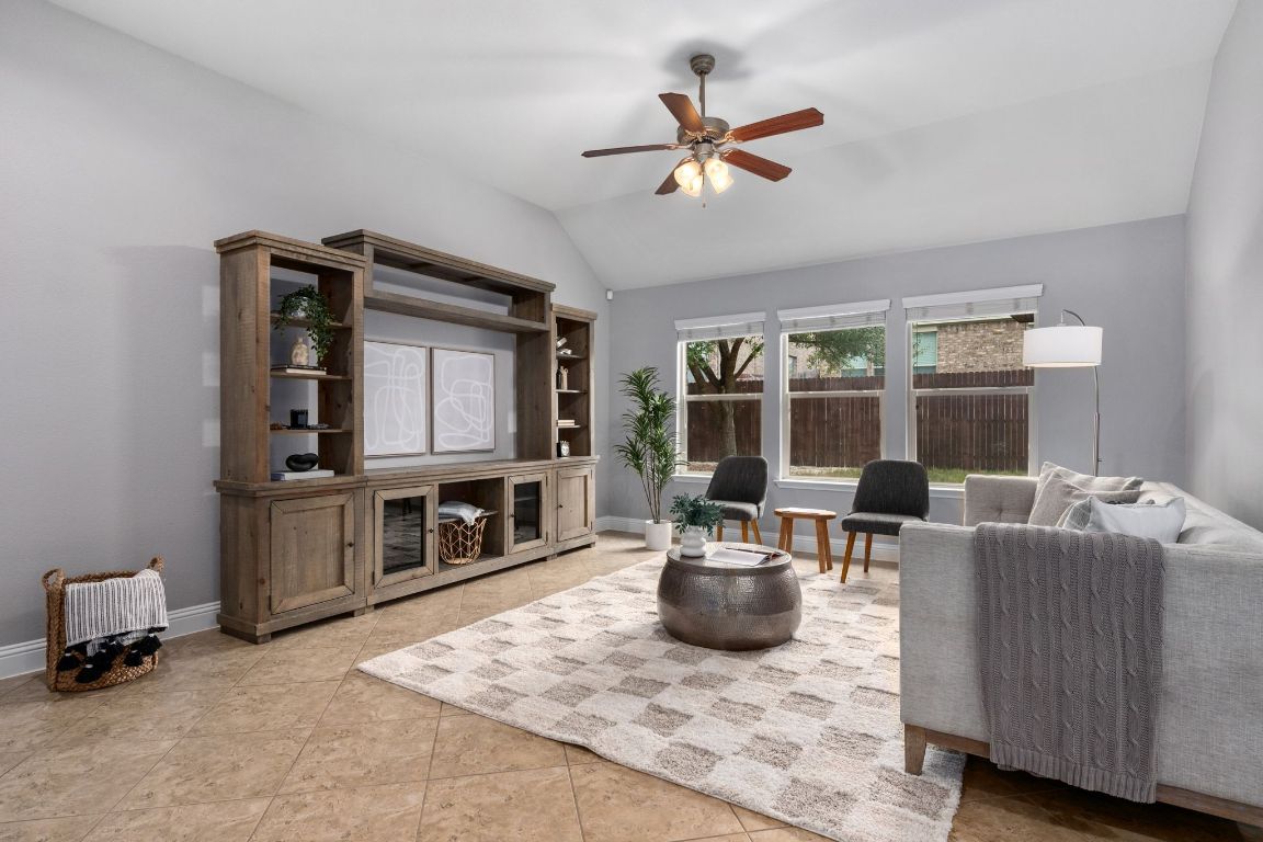 2041 Elaina Loop Leander, TX 78641 - Photo 3 of 25 High ceilings and open space gives the living area warm cozy vibes.