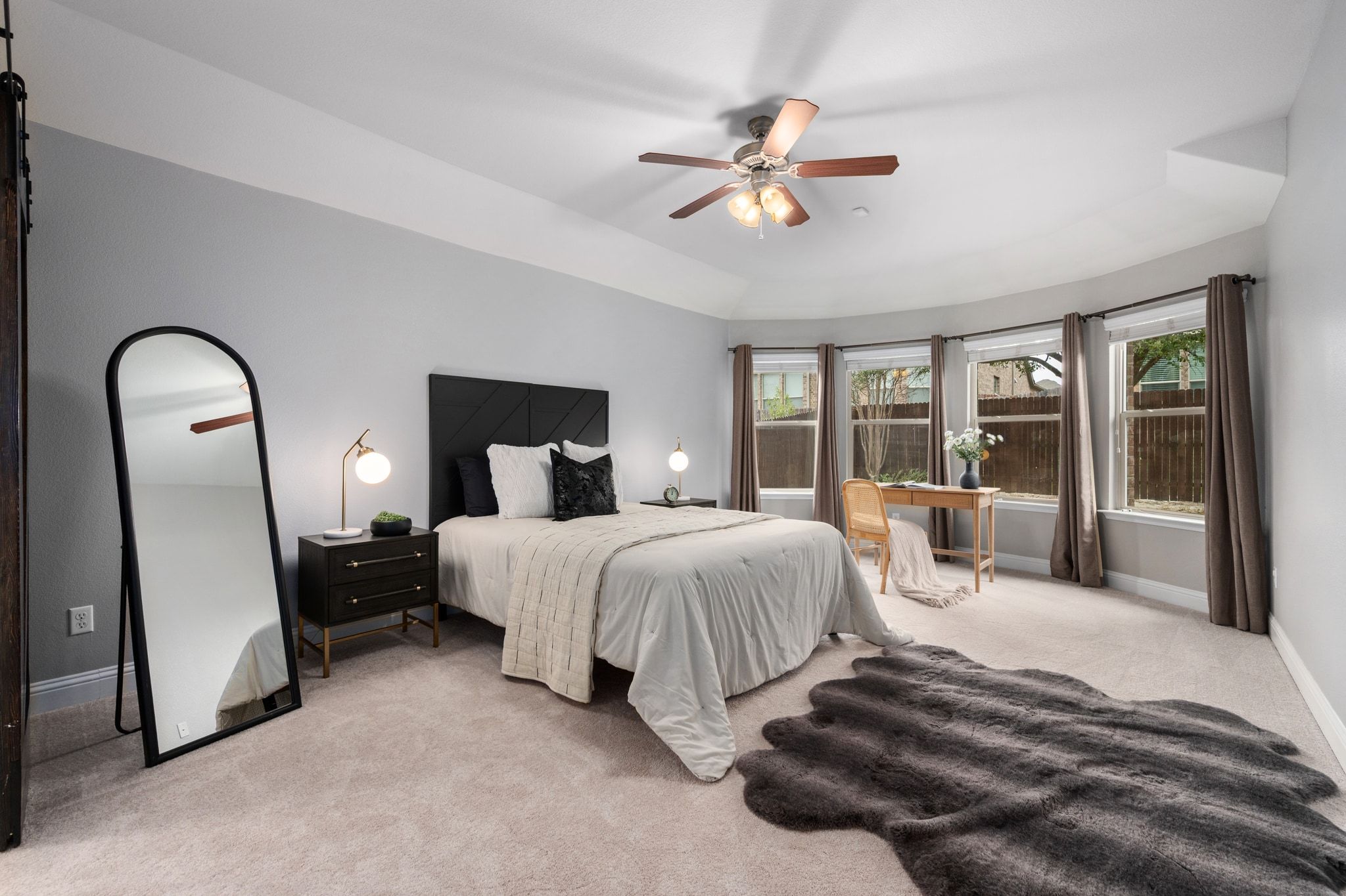 2041 Elaina Loop Leander, TX 78641 - Photo 4 of 25 a spacious bedroom with a bed a large window with couch