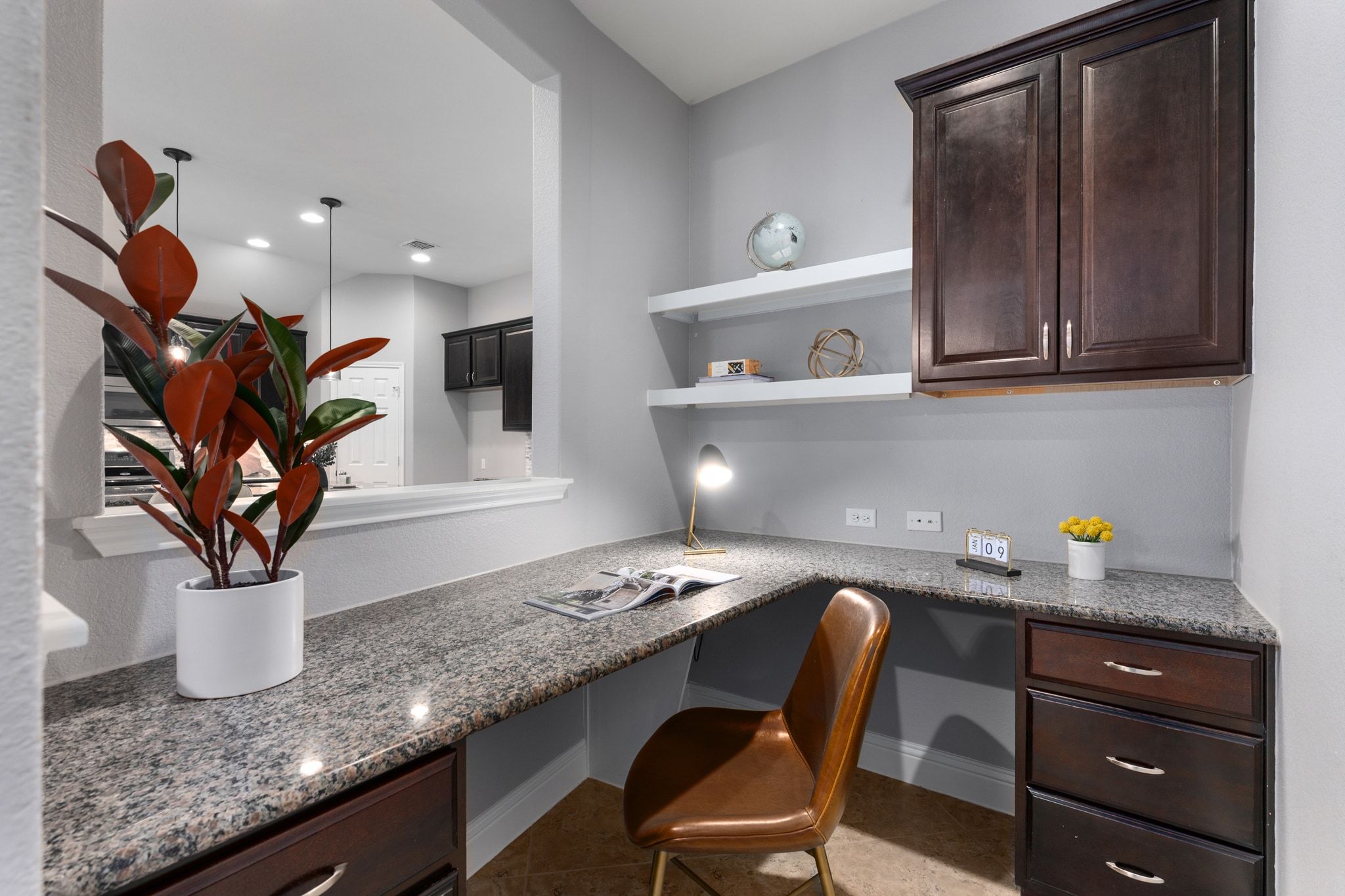 2041 Elaina Loop Leander, TX 78641 - Photo 5 of 25 a kitchen with a sink a microwave and cabinets