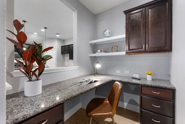 a kitchen with a sink a microwave and cabinets